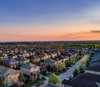 an aerial shot of houses in a subdivision and the horizon
